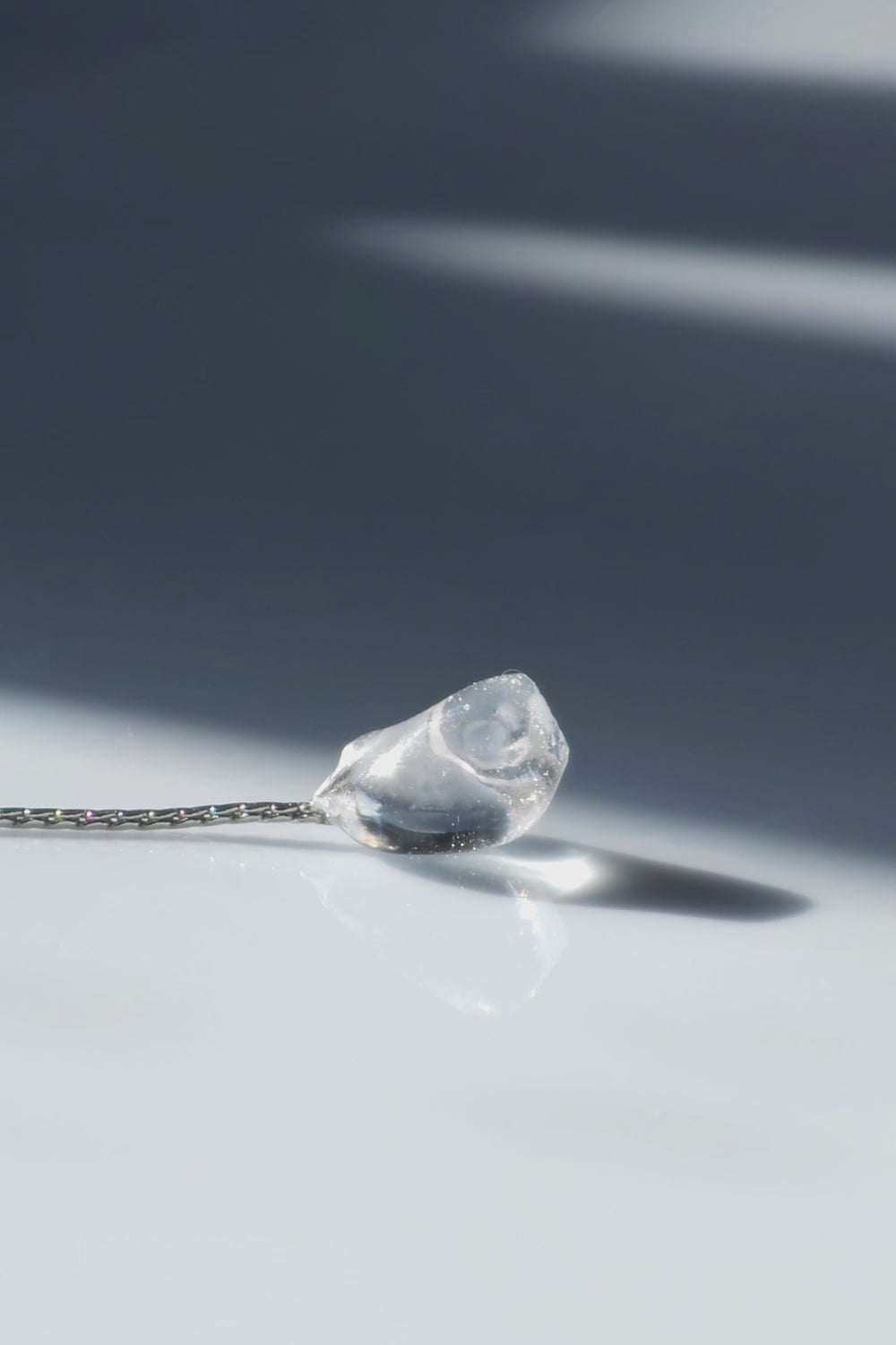 Video of flatlay of NAMI multiway short drop earring with pearls, silvery-blue stone, and removable chain for minimal or fluid styling.