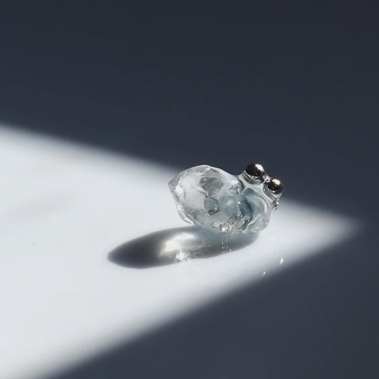 Video fo NAMI stud earring with silvery-blue hand-molded stone and three tiny silver orbs, inspired by ocean waves, shown alone for a minimal look.