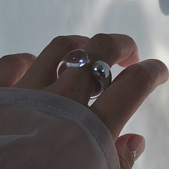 Model wearing TORORI silver as a ring, showcasing sculptural dripping water-inspired design with clear resin details.