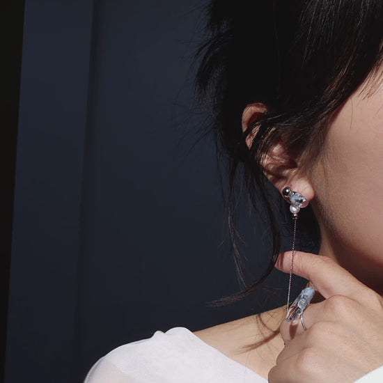 Video showcasing how to wear NAMI multiway drop earring showcasing detachable chain, freshwater pearl, and fluid silvery-blue glow.
