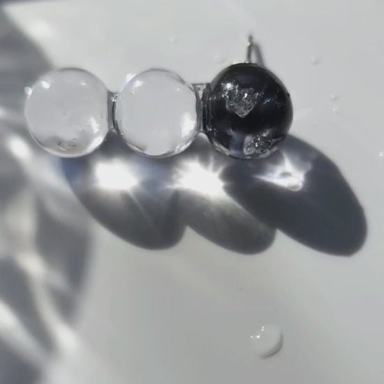Close-up video of SORA vertical orb earrings showing gradient blue hues. Each orb is uniquely handcrafted.