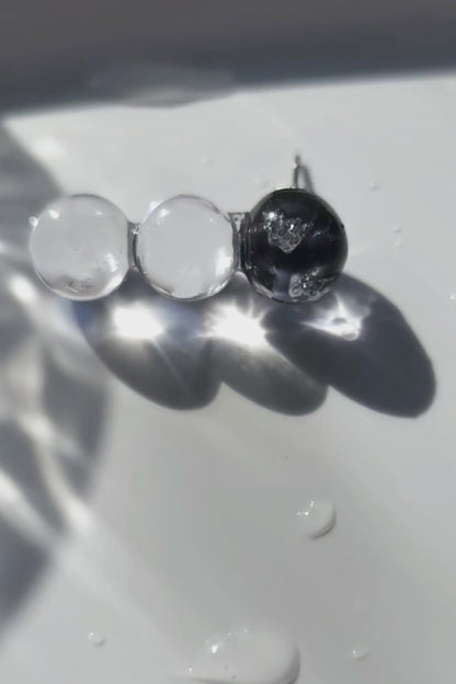 Close-up video of SORA vertical orb earrings showing gradient blue hues. Each orb is uniquely handcrafted.