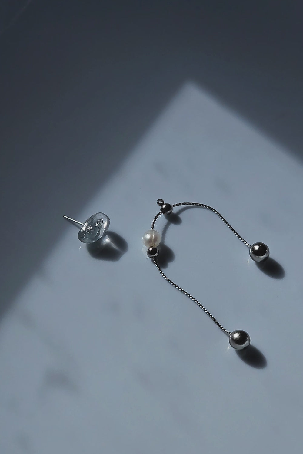 Video of NAMI multiway drop earring with adjustable chain and pearl, silvery-blue wave-inspired design.