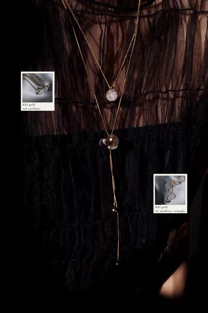 REI gold / orb necklace