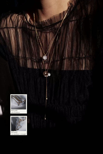 REI gold / tie necklace - triangle