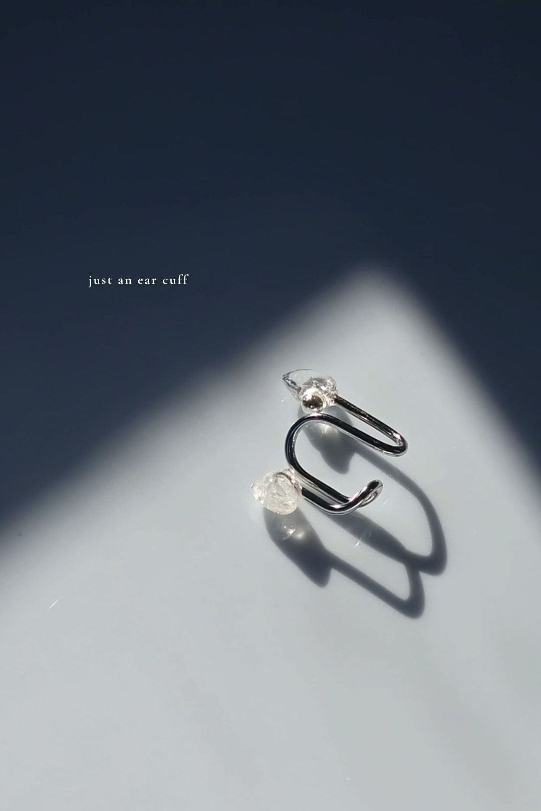 REI multiway ear cuff and ring set shown detached and only the ear cuff is laying.