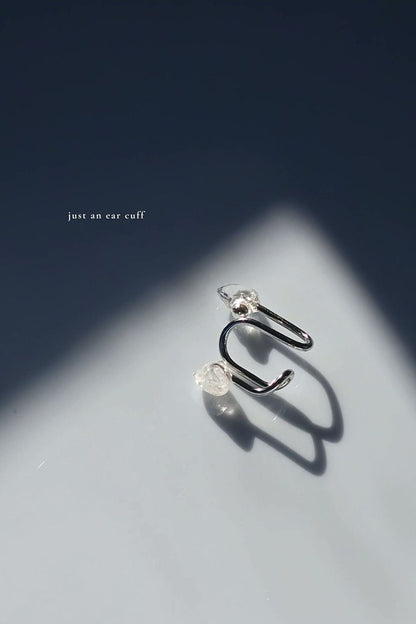 REI multiway ear cuff and ring set shown detached and only the ear cuff is laying.