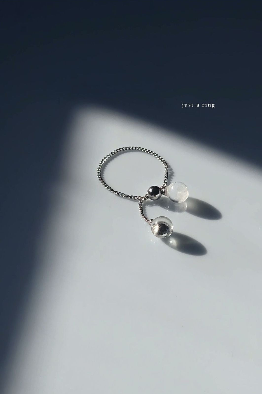 REI multiway ear cuff and ring set shown detached, only the ring is showing with the adjustable slide ball.