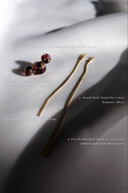 SAKURAMBO multiway chain ear cuff in dark cherry red with one chain detached, flat lay on neutral background with description.