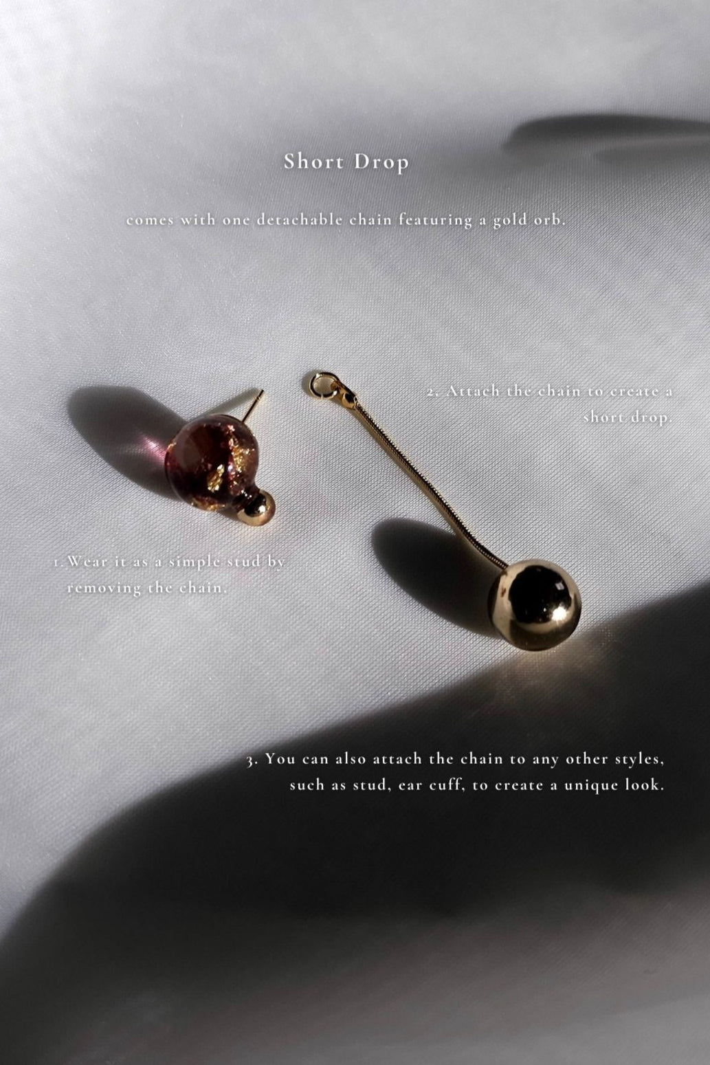 Orb drop in dark cherry with a detachable gold orb, SAKURAMBO short drop, on a flat surface.