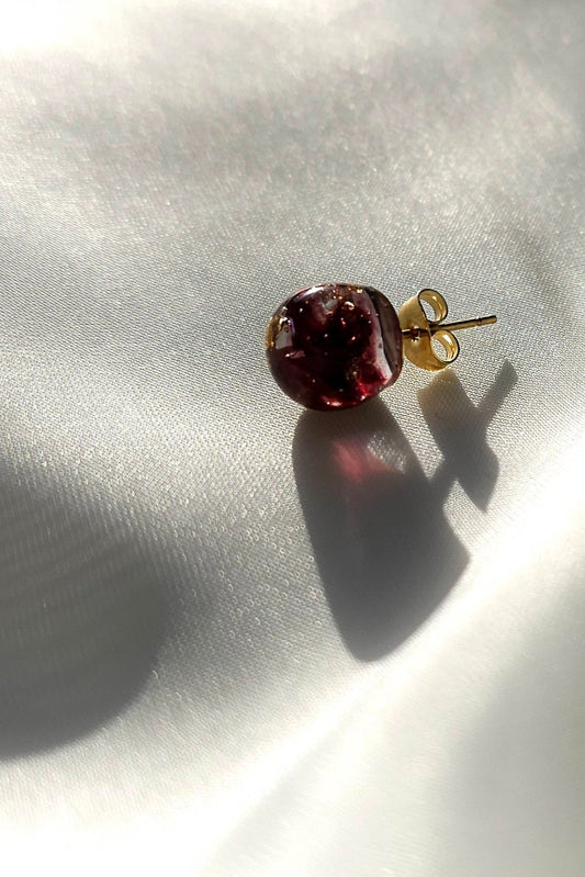 10mm orb stud in dark cherry on flat surface.