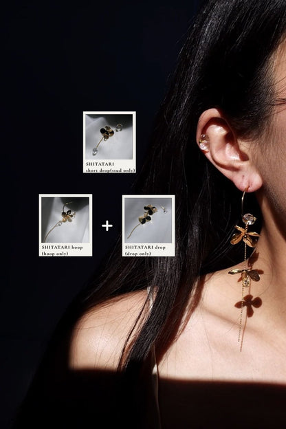Model wearing cler stone earring, a stud from the SHITATARI gold short drop, on helix, and gold hoop earring, SHITATARI gold hoop, paired with the drop part drom gold floral earring, SHITATARI drop.