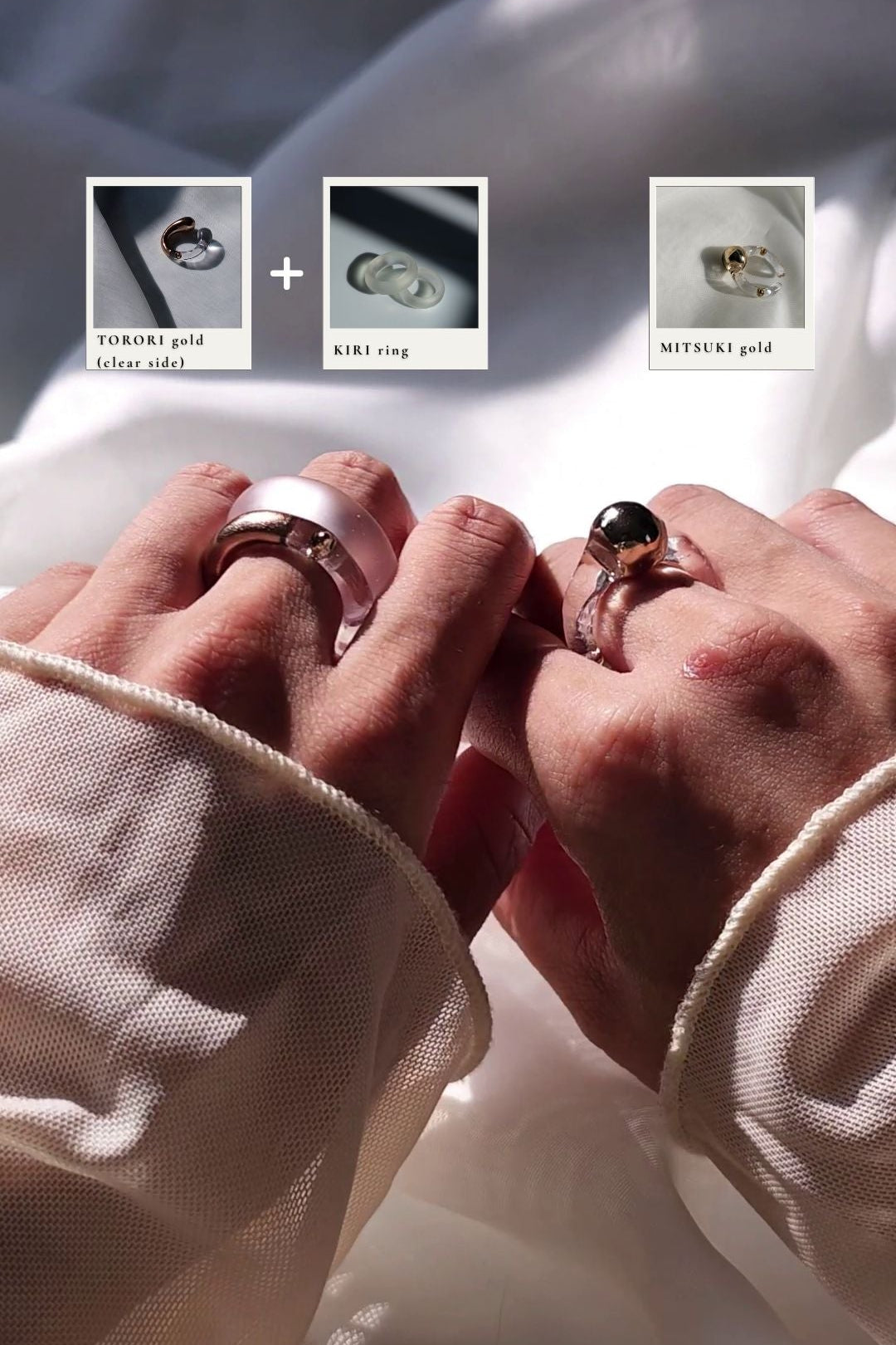 Two hands wearing 3 rings, TORORI gold sculptural ring showing the clear side to the top, stacked with KIRI frosty ring on the left index finger, MITSUKI gold orb ring on the right middle finger.