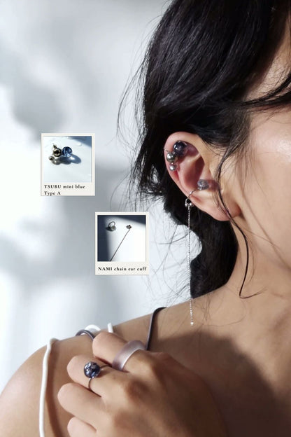 Model wearing TSUBU mini blue on helix with NAMI multiway chain earcuff on cartilage.