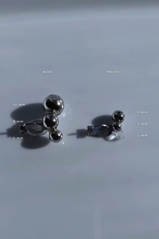 Flatlay of TSUBU mini silver and TSUBU micro silver comparing the desin and the size.