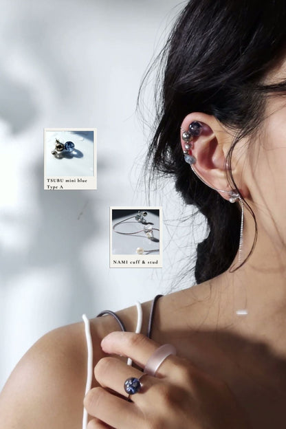 Model wearing TSUBU mini blue blimber on helix with NAMI cuff & stud.