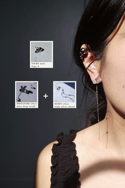 Close-up of a person wearing TSUBU mini silver type A on the helix and the stud of the shitatari silver short drop with the chain from HISEN silver