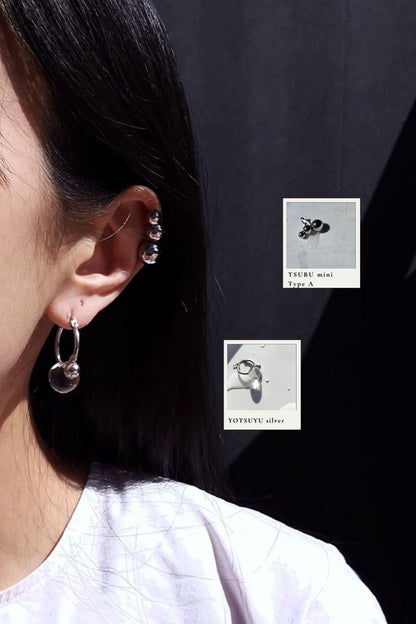 Model wearing YOTSUYU silver huggie with TSUBU mini silver Type A on helix.