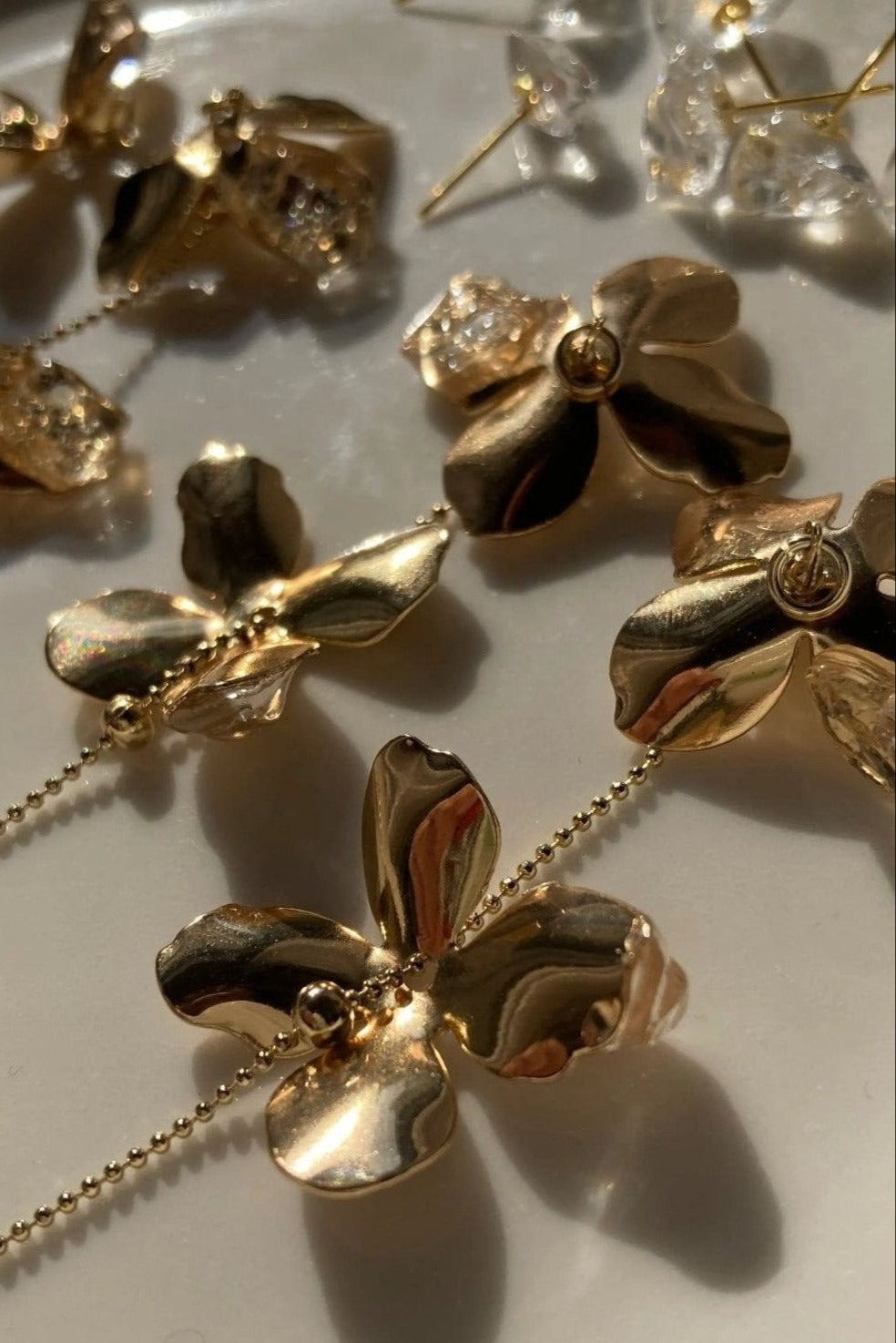 Shitatari Gold Chain Floral Earrings and Crystal Studs layout
